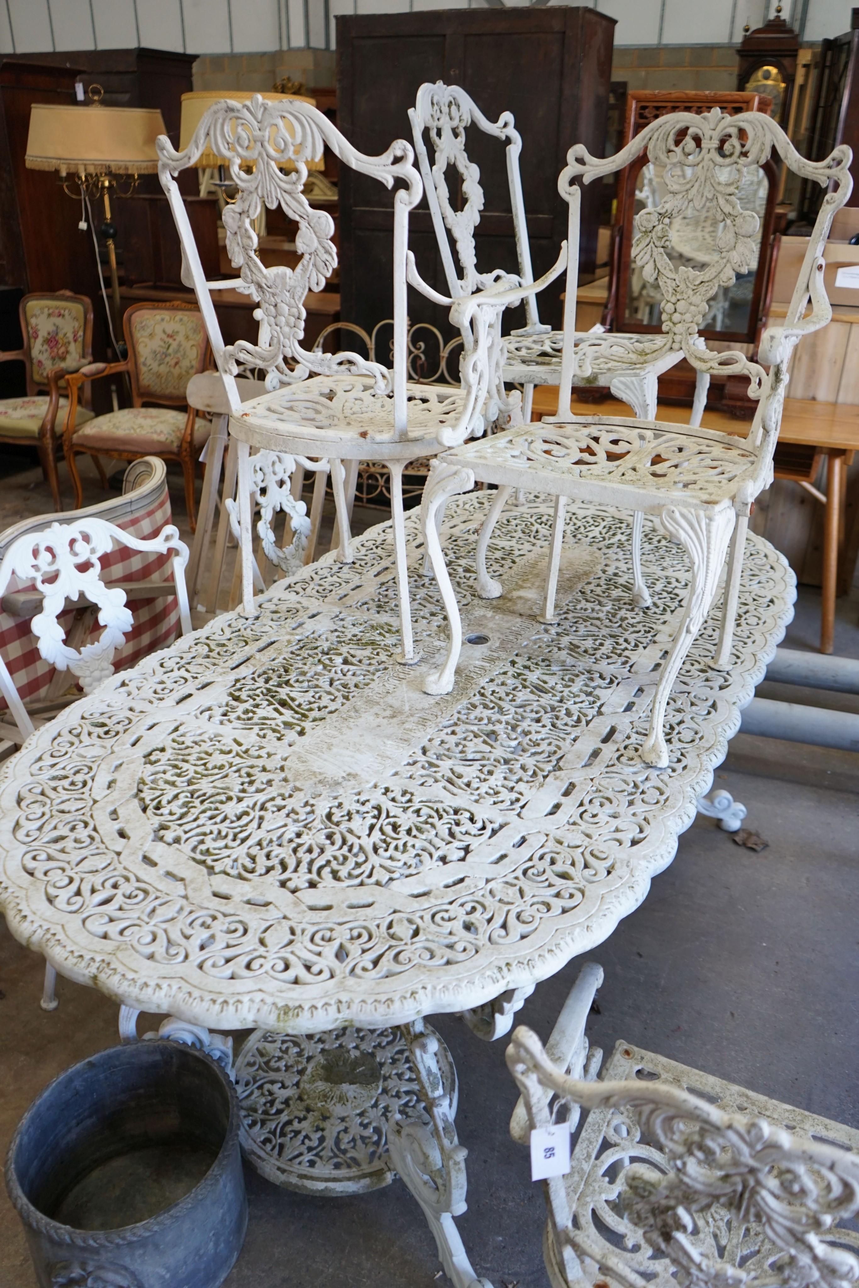 A Victorian style painted aluminium garden table, length 186cm, depth 94cm, height 72cm and six chairs in two sizes, two with arms